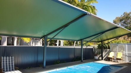 Waterproof pool shade structure designed, manufactured, and installed by Versatile Structures