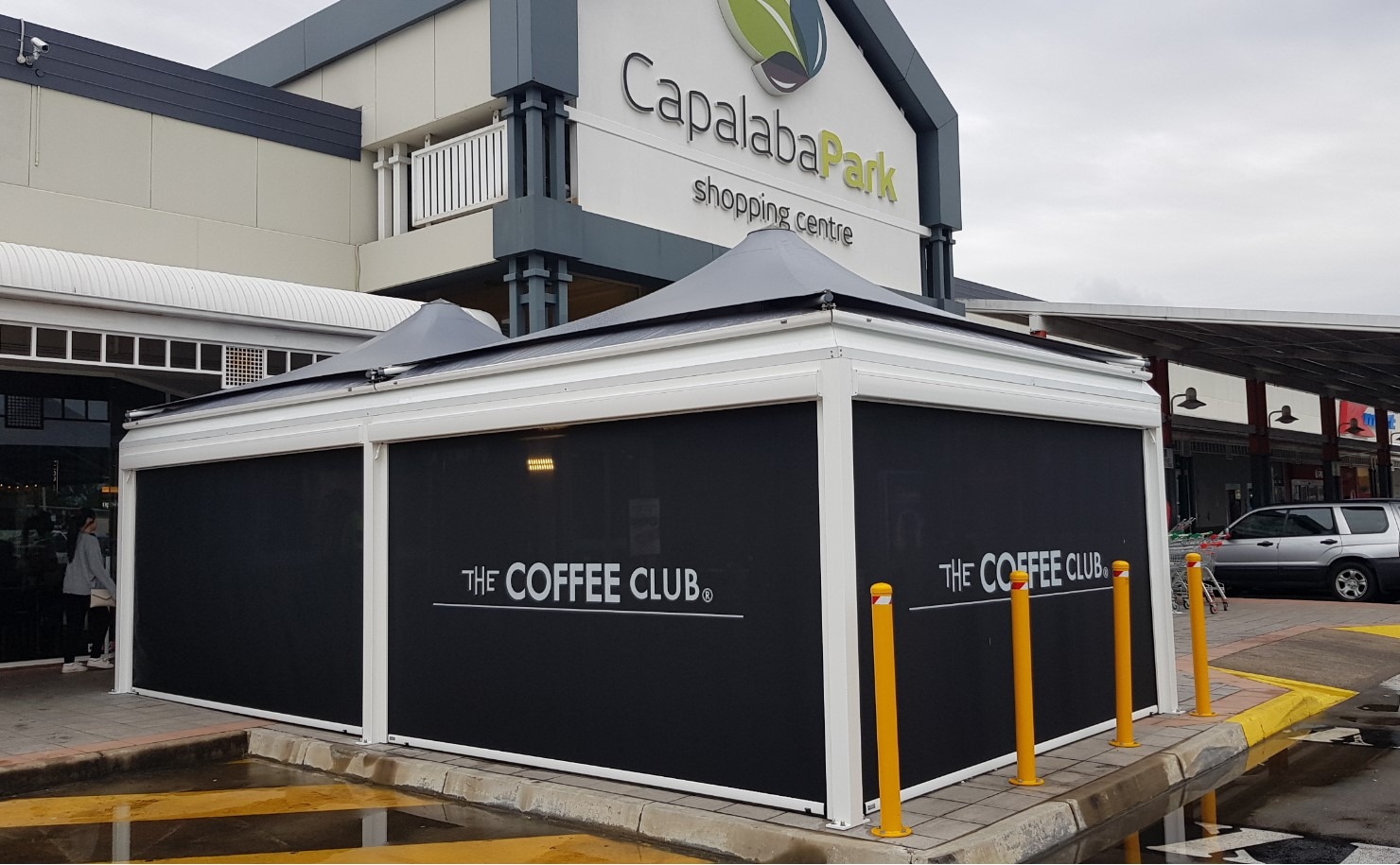 Custom branded outdoor dining solution for The Coffee Club designed, manufactured, installed by Versatile Structures