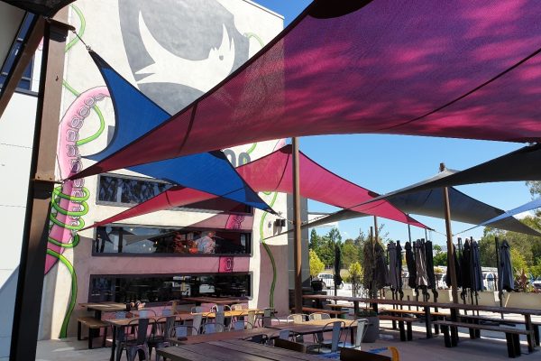 Colourful shade sails installed by Versatile Structures for Brewdog