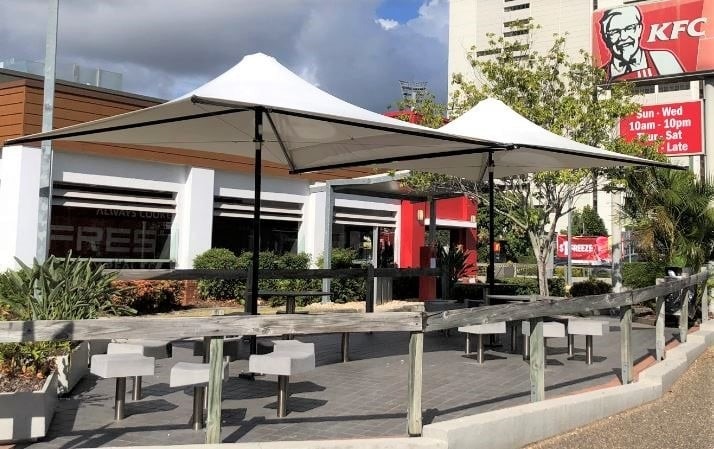 Waterproof café umbrella installed for KFC by Versatile Structures