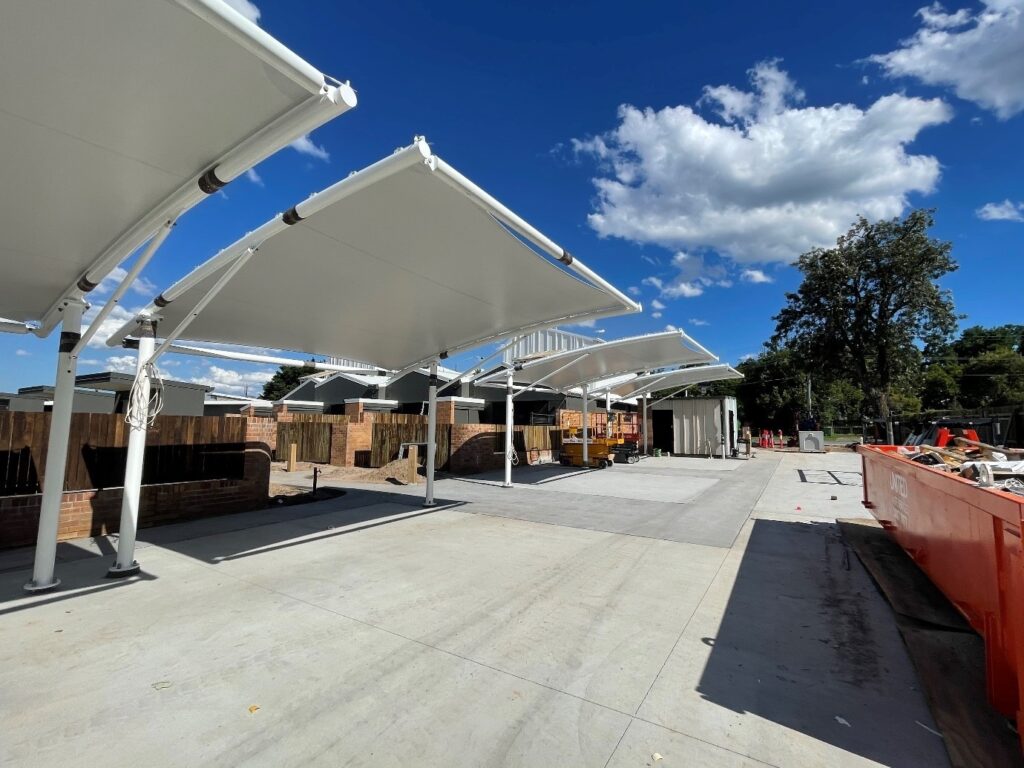 Waterproof shade sails installed for habitat on Juers by Versatile Structures